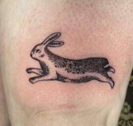 A tiny tattoo of a rabbit done by Basic Urban Witch Tattoo and Tarot in Fort Collins Colorado.