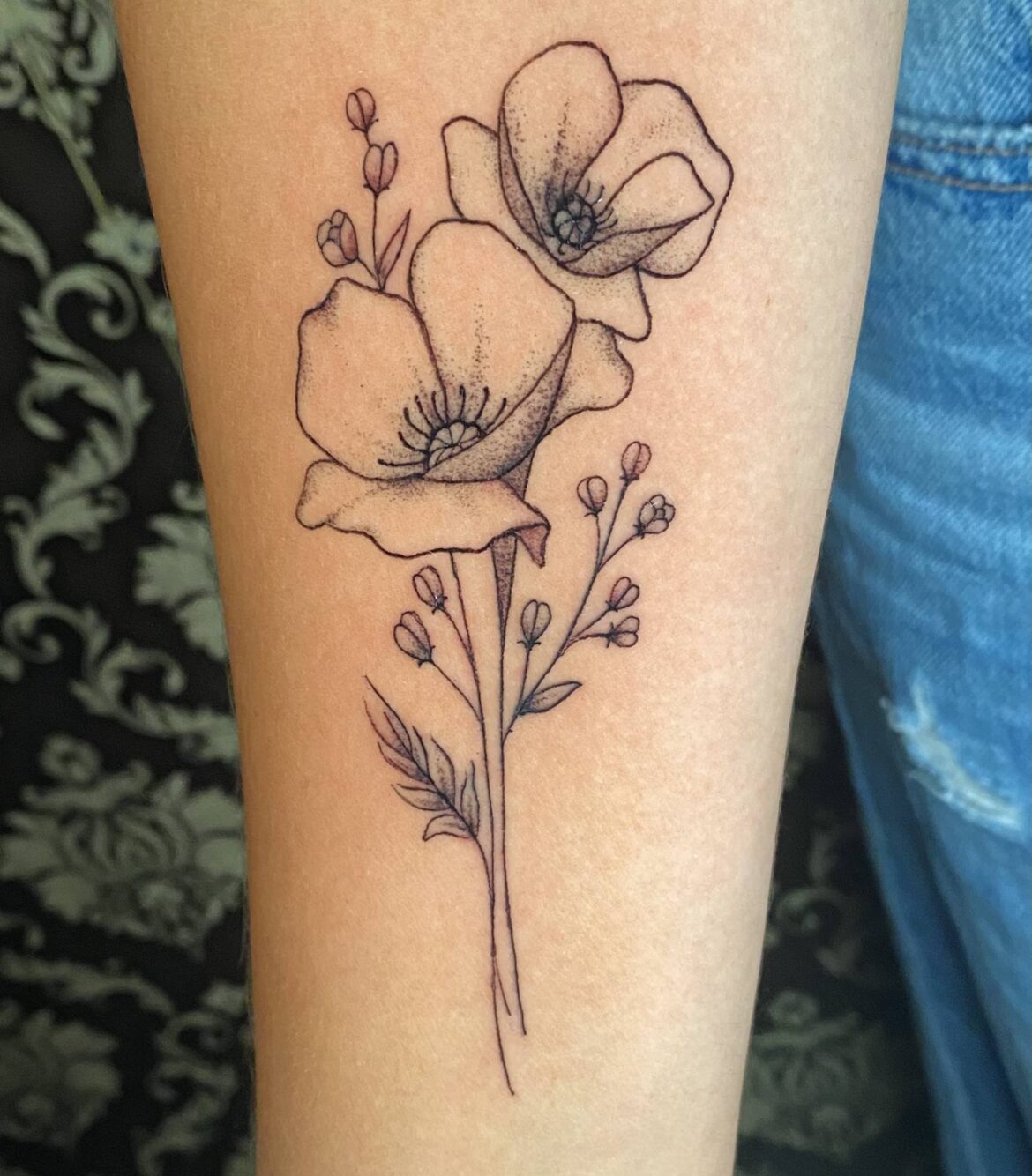 A pair of minimalist single needle flowers tattooed by Basic Urban Witch Tattoo and Tarot in Fort Collins Colorado.