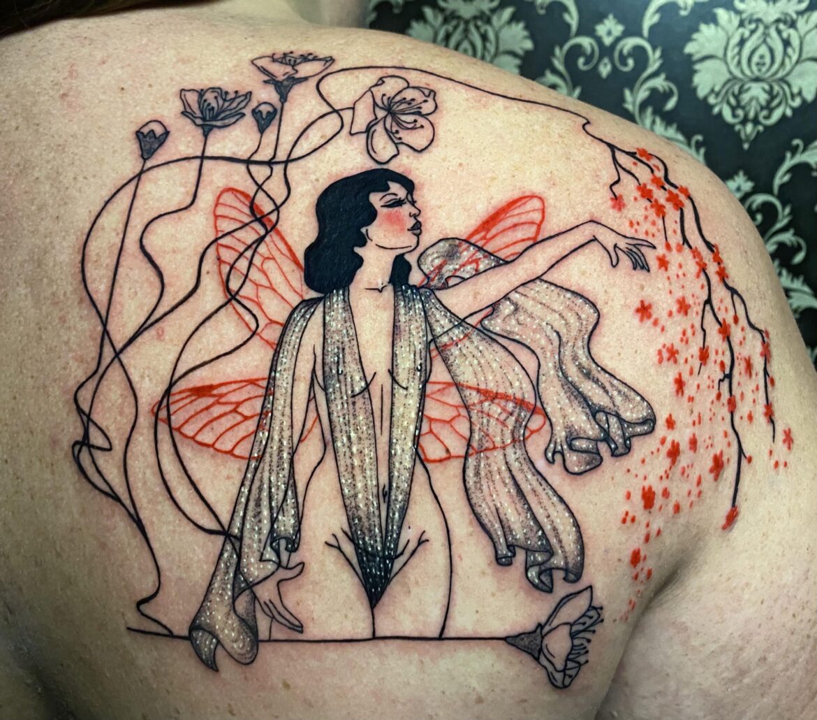 A perfect example of the artists work this features their signature fine line style with glitter tattoo aspects placed upon an art deco fairy design. This tattoo was designed and applied by Fort Collins premier fine line tattoo artist Basic Urban Witch Tattoo and Tarot.